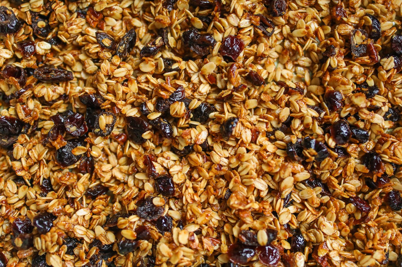 Close-up of homemade granola with oats and raisins, showcasing a healthy snack option.