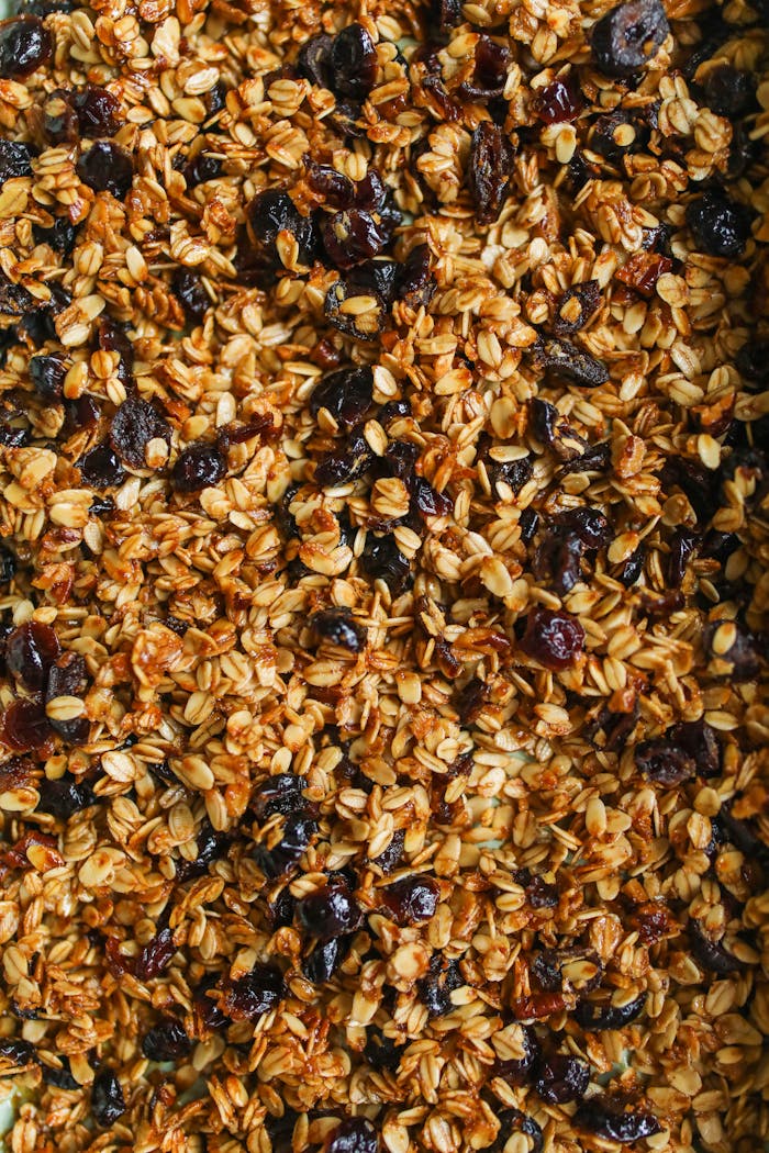 Delicious homemade granola with oats, nuts, and raisins, perfect for a healthy breakfast.