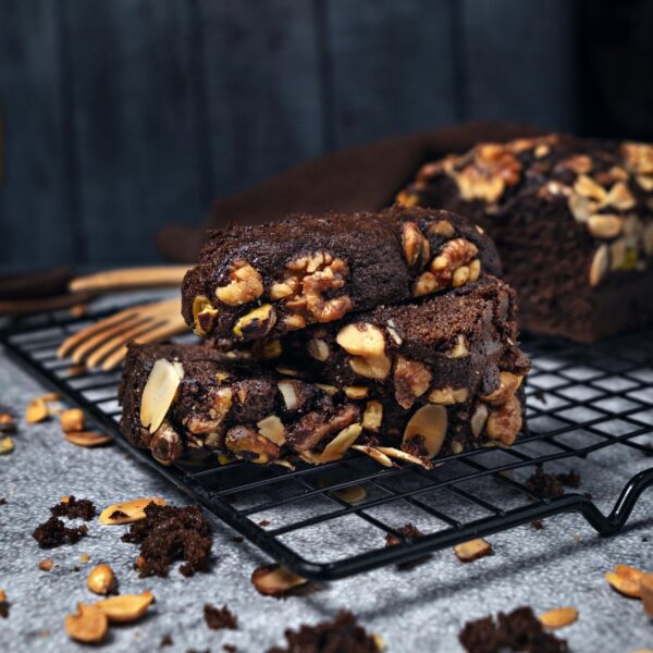 Close-up of homemade chocolate brownies with nuts on a cooling rack.